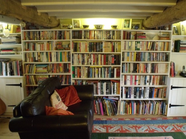 Front view of traditional fitted pine shelving and cupboards in an English period cottage.
