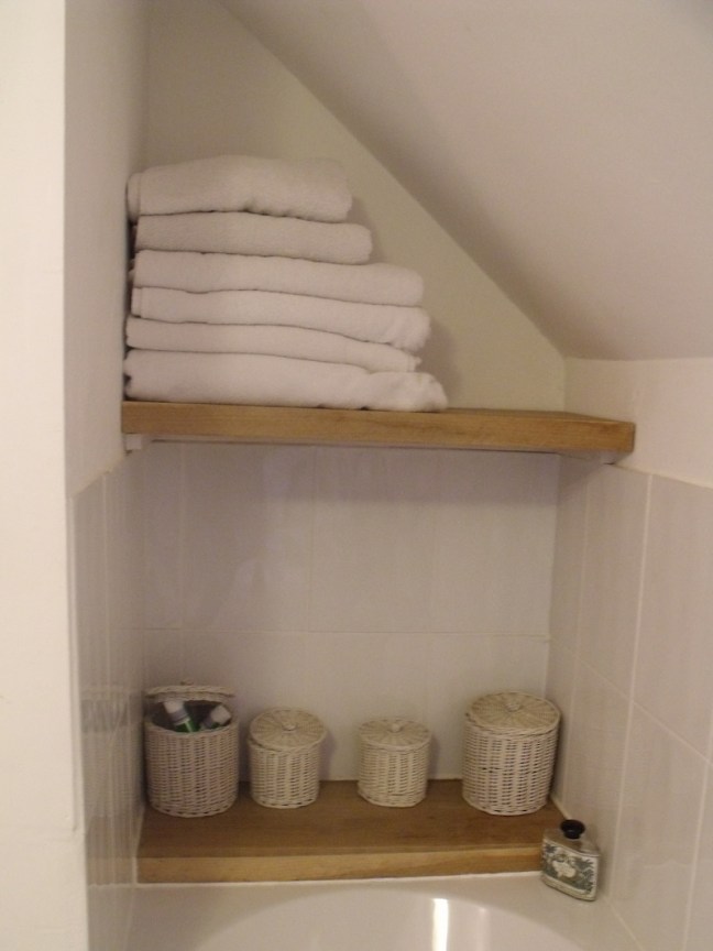 oak shelving above a bath